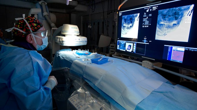 A doctor in a prepared hospital room for a surgery