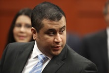 George Zimmerman sitting in a courtroom wearing a suit