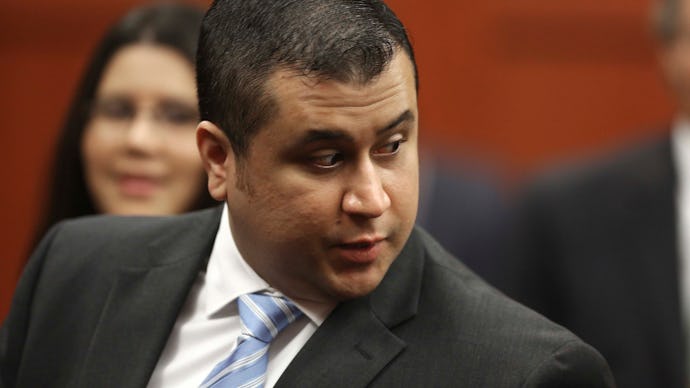 George Zimmerman sitting in a courtroom wearing a suit