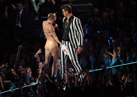 Robin Thicke and Miley Cyrus performing at the 2013 VMAs, as Miley grabs Robin's crotch with a foam ...