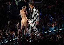 Robin Thicke and Miley Cyrus performing at the 2013 VMAs, as Miley grabs Robin's crotch with a foam ...