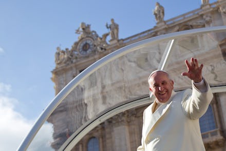 Pope Francis in all-white, waving and looking down