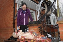 A man with his Halloween decorations featuring a very realistic rotting dead body 