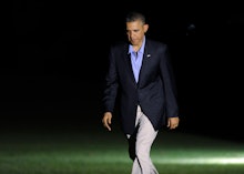 Obama walking in a black blazer