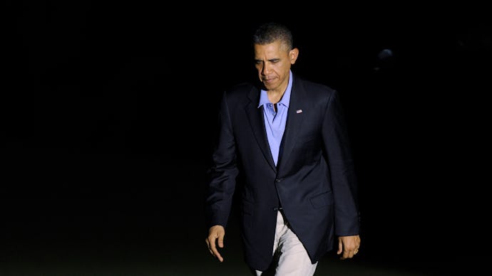 Obama walking in a black blazer