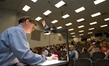 A man taking the national science quiz in front of an audience