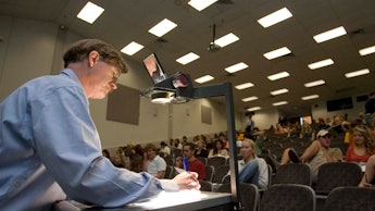 A man taking the national science quiz in front of an audience