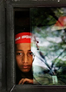 A female modern slave looking through a window at work