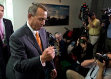 A congressman getting his picture taken by various journalists