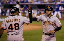 Pablo Sandoval, #48 of the San Francisco Giants, is congratulated by Travis Ishikawa #10 during a Ma...