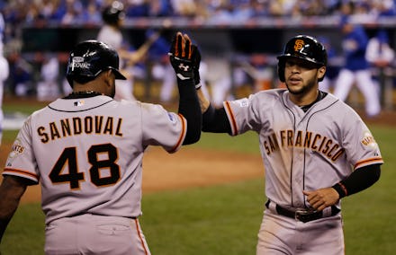 Pablo Sandoval, #48 of the San Francisco Giants, is congratulated by Travis Ishikawa #10 during a Ma...