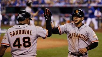 Pablo Sandoval, #48 of the San Francisco Giants, is congratulated by Travis Ishikawa #10 during a Ma...