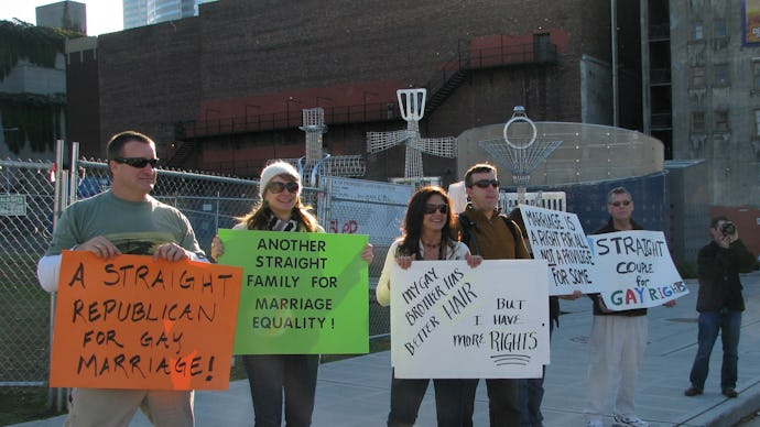 A group of lgbt allies standing on the streets with signs of support