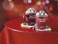 Two red mugs with McDonald's peppermint mocha and peppermint hot chocolate bagged coffee