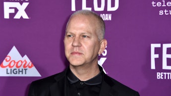 Ryan Murphy in a black shirt, and a black blazer at a red carpet event