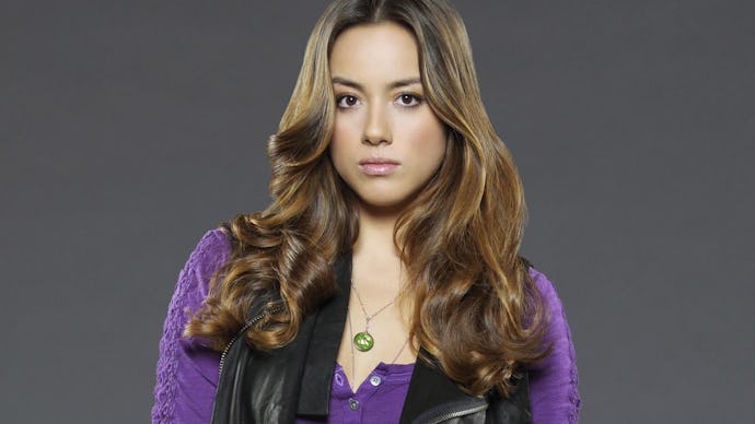 Chloe Bennet posing for a photo in a purple shirt