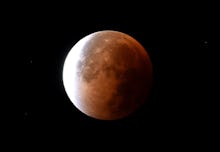 The moon going through the process of a lunar eclipse