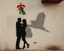 A graffiti of a couple hugging under the mistletoe