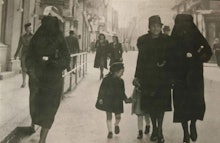 Muslim woman on the streets of Sarajevo, using her veil to cover her Jewish neighbor's yellow star i...