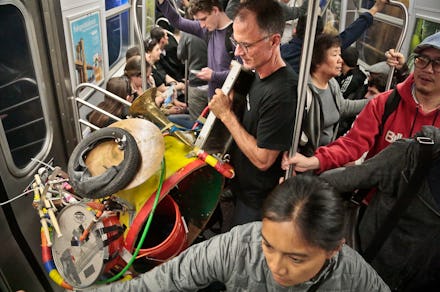 People standing on public transportation in the New York City