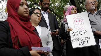Muslims protesting against NYPD surveillance, holding signs that say: stop spying on me!