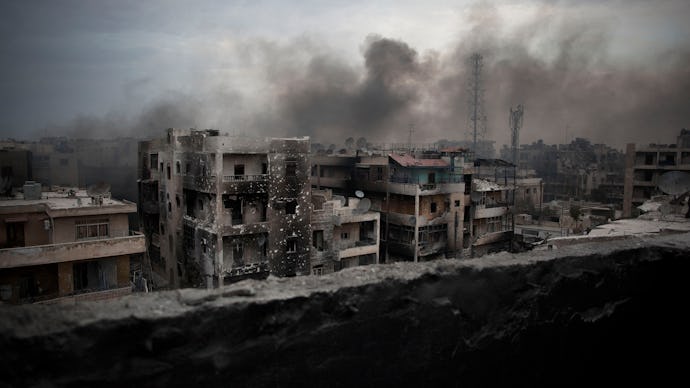A row of building in Syria in ruins, smoke and fire