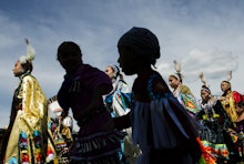 A group of Native Americans, who are considered to be a marginalized group walking down a street