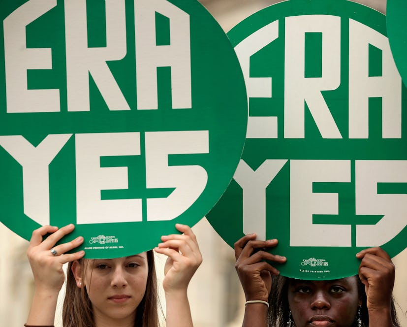 Girls holding era yes green signs