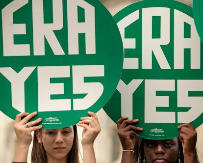 Girls holding era yes green signs