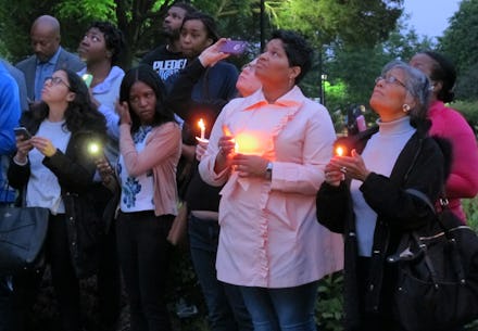 People holding candles for Richard Collins