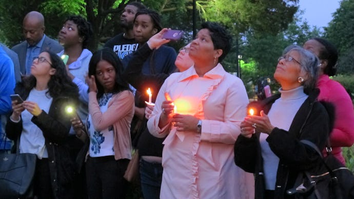 People holding candles for Richard Collins