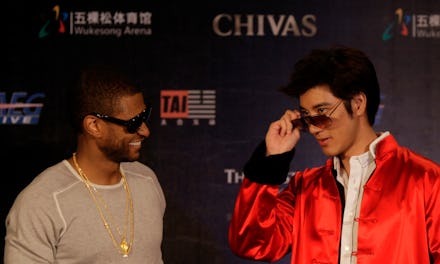 Usher in sunglasses with an Asian man next to him trying on Asian fit sunglasses