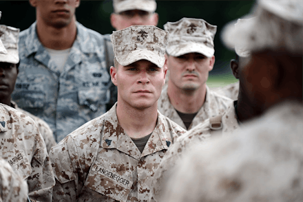 U.S. Marine Ryan Langenegger standing and listening to his instructor