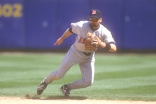 Chuck Knoblauch playing for the minnesota twins in the middle of a baseball game running between bas...