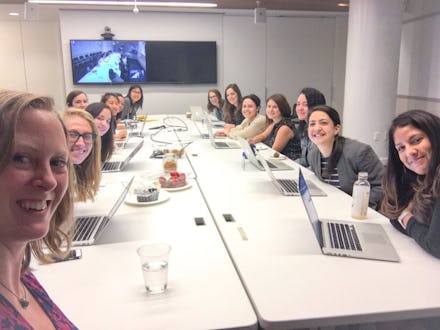 Twitter post of Liz Heron in which she is sitting at the job meeting