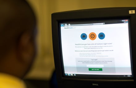 A man looking on a display with the option to sign up for Obamacare