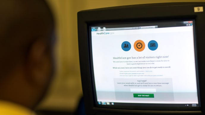 A man looking on a display with the option to sign up for Obamacare