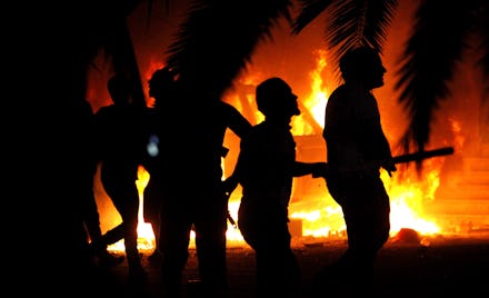 People fleeing a burning site after the attacks in Benghazi