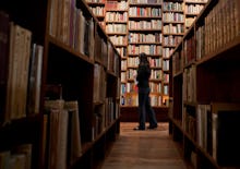 A young lady looking for a perfect read in a library