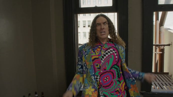 Weird Al Yankovic in a multicolored suit and shirt in the music video for "Tacky"