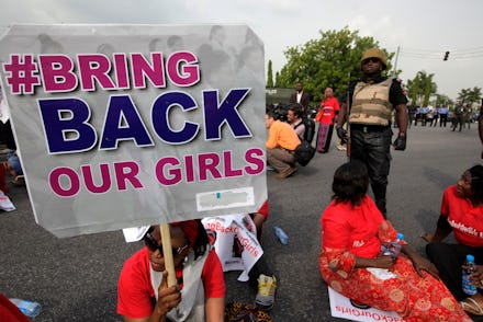  Protestors holding up signs to bring back the women and girls kidnapped by Boko Haram