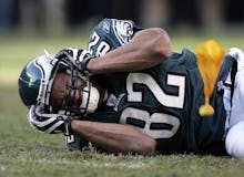 L.J. Smith laying on the ground, holding his head in pain, as his fall could've caused a concussion