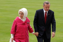 Emine Erdogan and Recep Tayyip Erdogan holding hands and walking