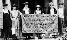 A group of suffragettes protesting for women's rights with a banner about parties discriminating aga...