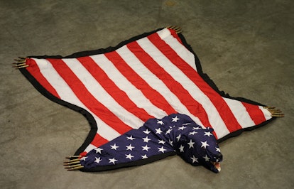 An art piece by Nicholas Galanin of an american flag made to look like a bear rug