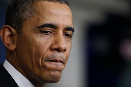 A close-up portrait of Barack Obama looking sad