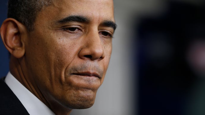 A close-up portrait of Barack Obama looking sad
