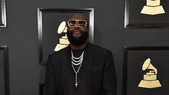 Rick Ross in a black coat and black pans at the Grammy Award Show