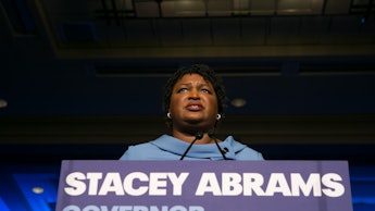 Governor Stacey Abrams in a blue dress giving a speech
