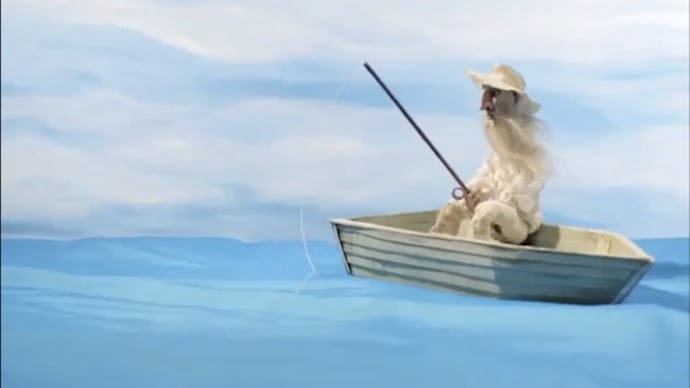 Man in white coat in the middle of the blue sea sitting in the boat and fishing from a 5-Second vide...